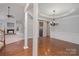 Spacious living room with hardwood floors, fireplace, and elegant chandelier at 1001 Hatton Ter, Fort Mill, SC 29707