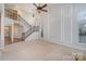 Open-concept living room with a staircase, high ceilings, and large windows at 1001 Hatton Ter, Fort Mill, SC 29707