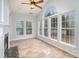 Bright sunroom with a fireplace, tile floor, and a ceiling fan at 1001 Hatton Ter, Fort Mill, SC 29707