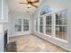 Bright sunroom with a fireplace, tile floor, and a ceiling fan at 1001 Hatton Ter, Fort Mill, SC 29707