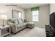 Living room with sectional sofa and green accent pillows at 147 Basildon St # 1007, Lancaster, SC 29720