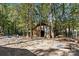 Serene backyard with a shed and cornhole games, ideal for outdoor activities at 1473 Polk Ford Rd, Stanfield, NC 28163