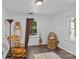 Cozy bedroom with rocking chair, window seat, and wicker bassinet at 1473 Polk Ford Rd, Stanfield, NC 28163