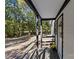 Inviting front porch with wooden flooring, offering a peaceful view of the backyard at 1473 Polk Ford Rd, Stanfield, NC 28163