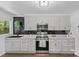 Modern kitchen features gray cabinets, black tile backsplash, and stainless steel appliances at 1473 Polk Ford Rd, Stanfield, NC 28163