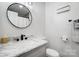 Stylish bathroom with marble vanity and round mirror at 1509 Cripple Creek Rd, Kannapolis, NC 28081