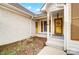 Front entryway with yellow door and brown shutters at 1509 Cripple Creek Rd, Kannapolis, NC 28081