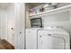 Bright laundry room with washer, dryer, and ample shelving at 1509 Cripple Creek Rd, Kannapolis, NC 28081