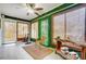 Relaxing sunroom featuring a ceiling fan and lush greenery at 1509 Cripple Creek Rd, Kannapolis, NC 28081