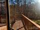 Back deck with wood railing overlooking the back yard and trees at 2015 Pine Needle Ct, Gastonia, NC 28056
