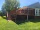Outdoor wooden deck and brick house in a lawn at 2015 Pine Needle Ct, Gastonia, NC 28056
