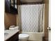 Cozy bathroom features a vanity, toilet, and tub with shower with a stylish patterned curtain at 2015 Pine Needle Ct, Gastonia, NC 28056