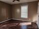 Bedroom with wood floors and a window with blinds at 2015 Pine Needle Ct, Gastonia, NC 28056