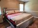 Cozy bedroom with a comfortable queen bed, neutral walls, and natural light from the window at 2015 Pine Needle Ct, Gastonia, NC 28056