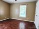 Bedroom with hardwood floors, neutral colors, and a bright window at 2015 Pine Needle Ct, Gastonia, NC 28056
