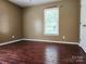 Hardwood floored bedroom with neutral colors and a bright window at 2015 Pine Needle Ct, Gastonia, NC 28056