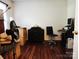 Office with desk, chair, chest of drawers, and wooden floors, bathed in bright natural light at 2015 Pine Needle Ct, Gastonia, NC 28056