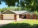 Charming single-story brick home featuring an attached two-car garage and a well-maintained front lawn at 2015 Pine Needle Ct, Gastonia, NC 28056