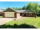 Charming single-story brick home featuring an attached two-car garage and a well-maintained front lawn at 2015 Pine Needle Ct, Gastonia, NC 28056