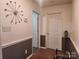 Hallway with neutral walls, wood floors, and a unique wall clock at 2015 Pine Needle Ct, Gastonia, NC 28056