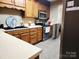Traditional kitchen featuring wood cabinetry, stainless steel appliances, and laminate countertops at 2015 Pine Needle Ct, Gastonia, NC 28056