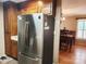 Stainless steel refrigerator with adjacent kitchen and dining areas at 2015 Pine Needle Ct, Gastonia, NC 28056