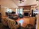 Inviting living room with a brick fireplace, hardwood floors, and an adjacent dining area at 2015 Pine Needle Ct, Gastonia, NC 28056