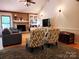 Warm living room with hardwood floors, a brick fireplace, and comfortable seating at 2015 Pine Needle Ct, Gastonia, NC 28056