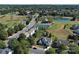 Aerial view showcases the neighborhood, pond, tennis courts, and lush greenery at 3007 Gambrill Falls Dr, Indian Trail, NC 28079