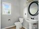 Cozy bathroom featuring a pedestal sink and a window bringing in plenty of natural light at 3007 Gambrill Falls Dr, Indian Trail, NC 28079