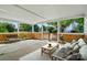 Covered porch is staged with neutral toned furniture at 3007 Gambrill Falls Dr, Indian Trail, NC 28079