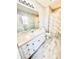 Bright bathroom featuring a white vanity with a granite countertop, a large mirror, and marble tile flooring at 301 Walkers Ridge Dr, Shelby, NC 28152