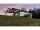 One-story house with carport and deck, at dusk at 301 Walkers Ridge Dr, Shelby, NC 28152