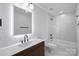 Clean bathroom with a modern bathtub, vanity, and geometric tile at 3216 High Ridge Rd, Charlotte, NC 28270