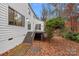 Back deck with steps leading to a wooded backyard at 3216 High Ridge Rd, Charlotte, NC 28270