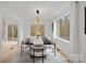 Elegant dining room features a dark wood table and stunning wooded views at 3216 High Ridge Rd, Charlotte, NC 28270