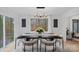 Bright dining room with modern table and chairs, featuring large windows and wooded views at 3216 High Ridge Rd, Charlotte, NC 28270