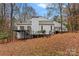 Rear view of house showcasing deck and wooded setting at 3216 High Ridge Rd, Charlotte, NC 28270