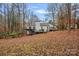 White house with deck and wooded lot at 3216 High Ridge Rd, Charlotte, NC 28270