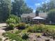 Landscaped backyard with lush gardens and a gazebo at 3613 Ridge Rd, Indian Trail, NC 28079