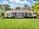 Ranch home with front porch, landscaping, and spacious lawn at 3613 Ridge Rd, Indian Trail, NC 28079