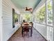 Relaxing screened porch with brick flooring, ceiling fan, and outdoor dining set at 3613 Ridge Rd, Indian Trail, NC 28079