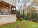 Backyard with wooden deck, stairs, and mature trees at 501 River Oaks Ln, Charlotte, NC 28226