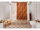 The bathroom has a patterned shower curtain, beige tile floors, and a basket of towels at 501 River Oaks Ln, Charlotte, NC 28226