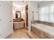 Elegant bathroom showcasing a soaking tub, separate shower, and stylish vanity with decorative lighting at 501 River Oaks Ln, Charlotte, NC 28226