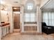 Elegant bathroom with a soaking tub, glass-enclosed shower, and decorative columns at 501 River Oaks Ln, Charlotte, NC 28226