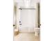 Bathroom with white tiled shower/tub combo, shower curtain and tile floor in a rendering at 501 River Oaks Ln, Charlotte, NC 28226