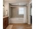 Neutral toned bathroom featuring tub, shower, vanity and wood look flooring in a rendering at 501 River Oaks Ln, Charlotte, NC 28226