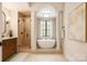 Stunning bathroom featuring a walk-in shower, soaking tub, and modern vanity with stylish fixtures at 501 River Oaks Ln, Charlotte, NC 28226
