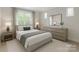 Bright bedroom featuring neutral decor and a large window offering natural light at 501 River Oaks Ln, Charlotte, NC 28226